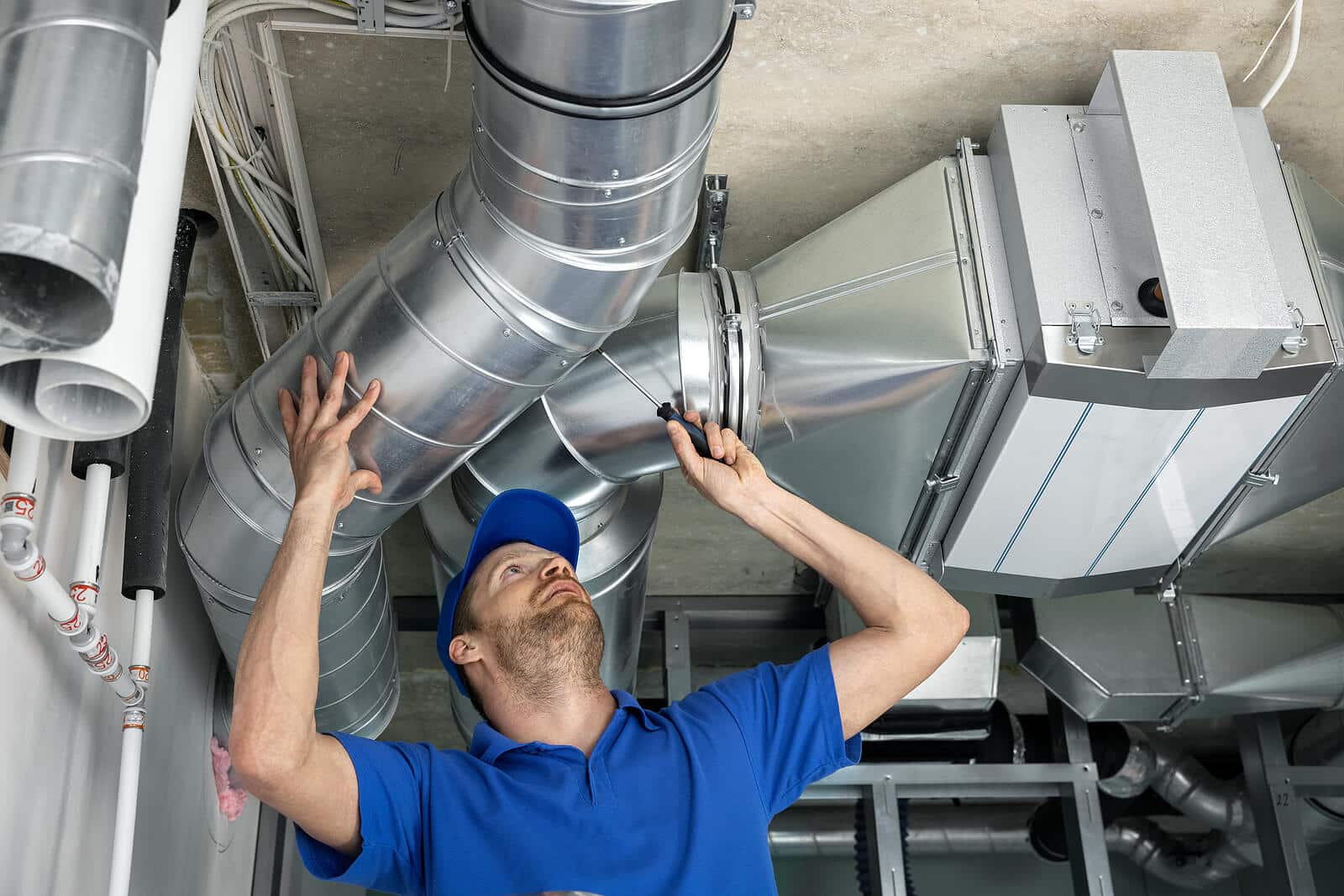 HVAC technician inspecting and repairing air ducts in Lawndale
