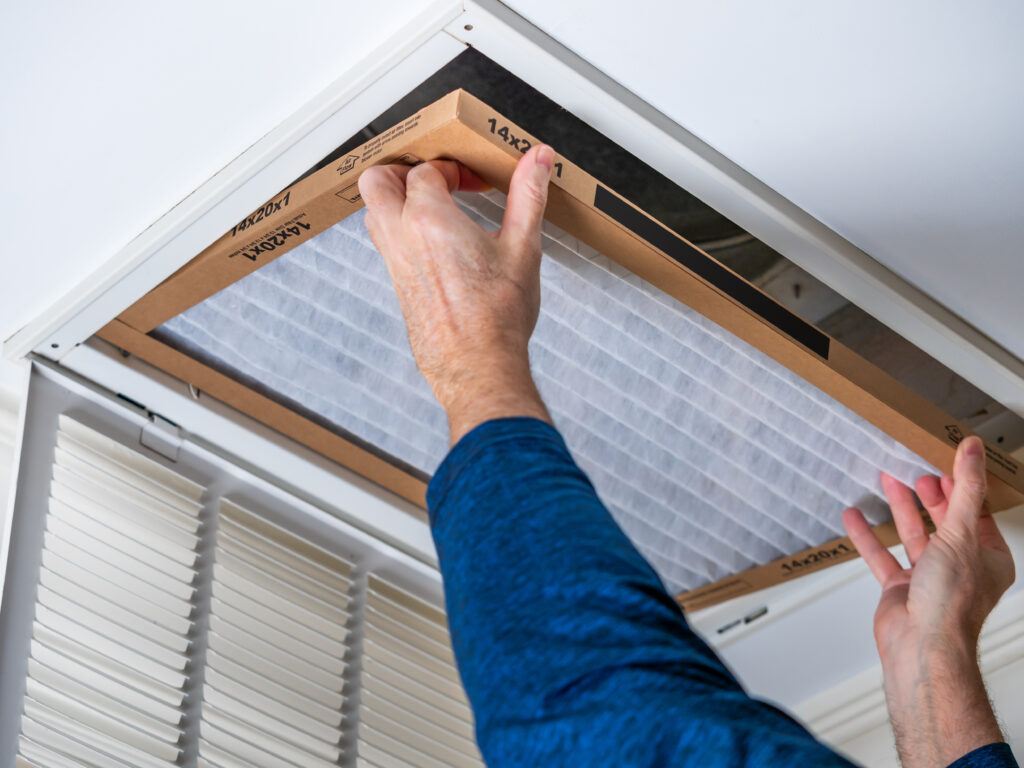 HVAC technician replacing a home air filter in Lawndale