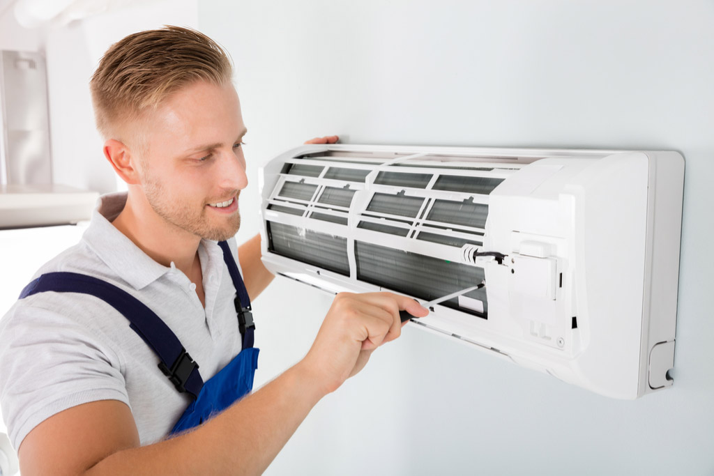 HVAC technician maintaining a ductless air conditioner in Lawndale
