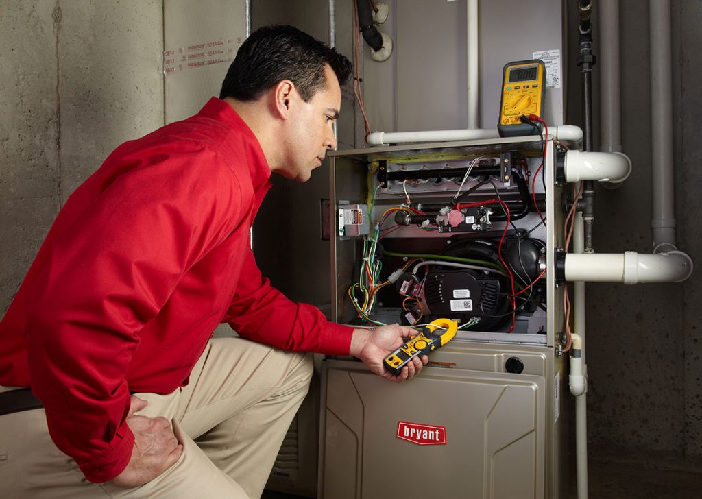 Heating technician diagnosing a furnace repair in Lawndale