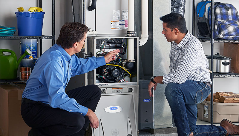 Technician evaluating a furnace for repair or replacement in Lawndale