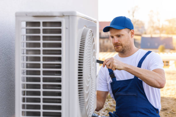 HVAC technician servicing an outdoor air conditioner in Lawndale