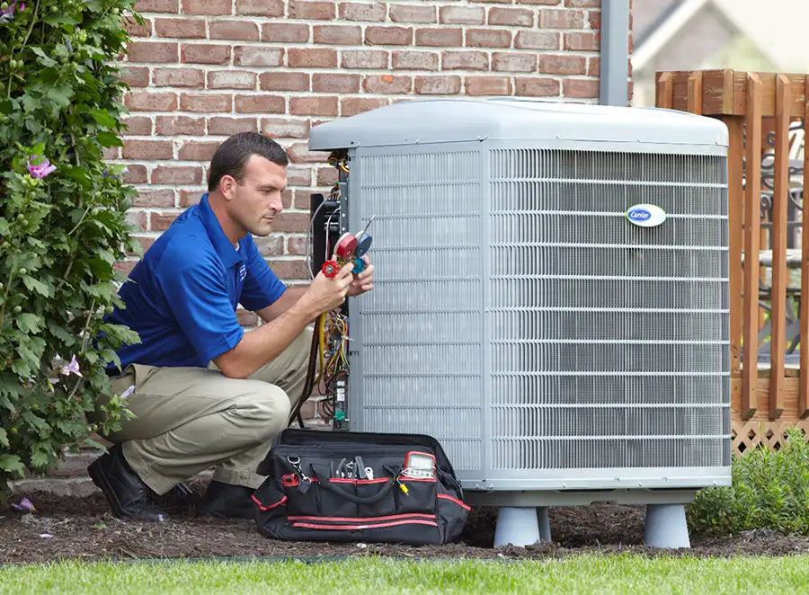 HVAC technician inspecting an outdoor AC unit in Lawndale